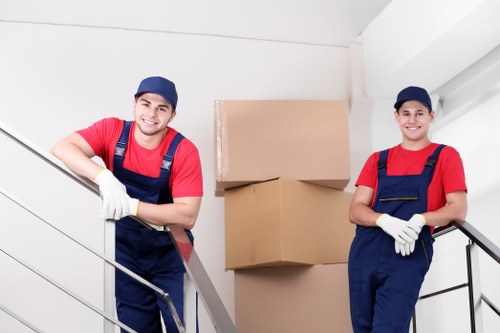 Moving home in Soho with careful handling of boxes and furniture in a central London street
