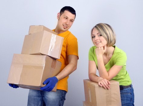 Mover carrying household items down stairs in a central London flat move
